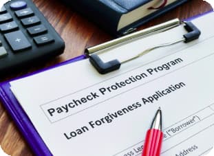PPP loan forgiveness application form with a pen